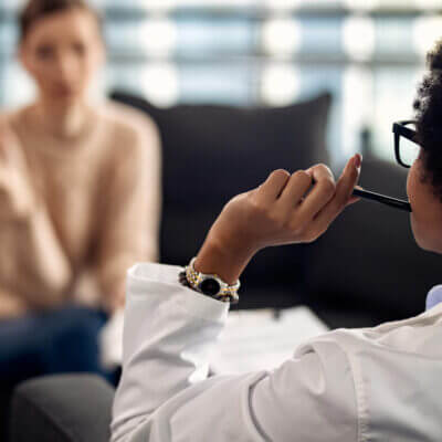 A psychologist sits in session with a patient