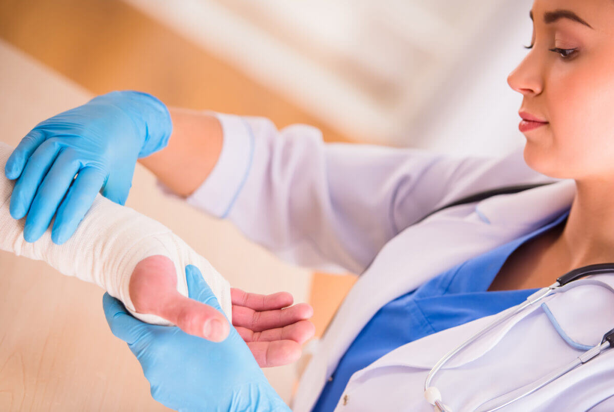 Nurse treating a patient's wounded hand