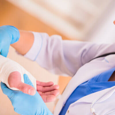 Nurse treating a patient's wounded hand