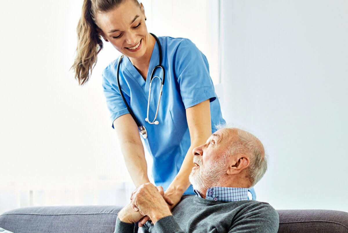 Nurse comforting an elderly patient