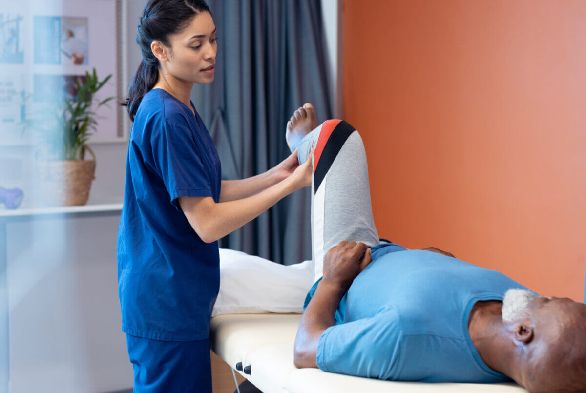 Physical therapist working with a patient's leg