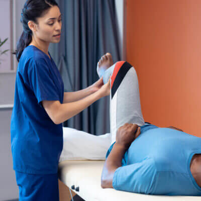 Physical therapist working with a patient's leg