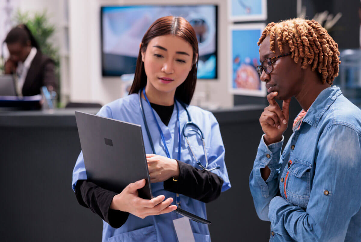 A nurse consults with a patient using a computer