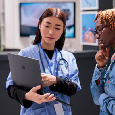 A nurse consults with a patient using a computer