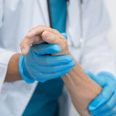 An orthopedic doctor examining a patient's hand