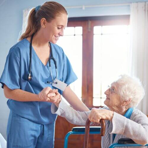 A nurse caregiver with a senior woman in her home
