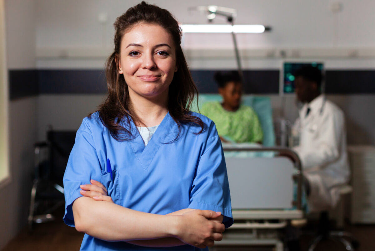 Young female nurse at a patient's bedside