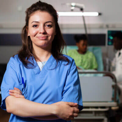 Young female nurse at a patient's bedside