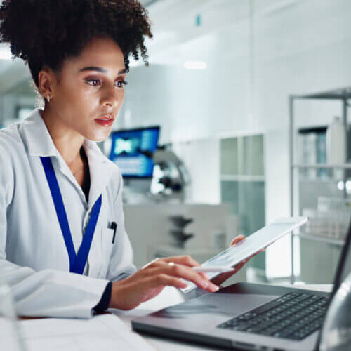 A doctor reviewing data on a computer